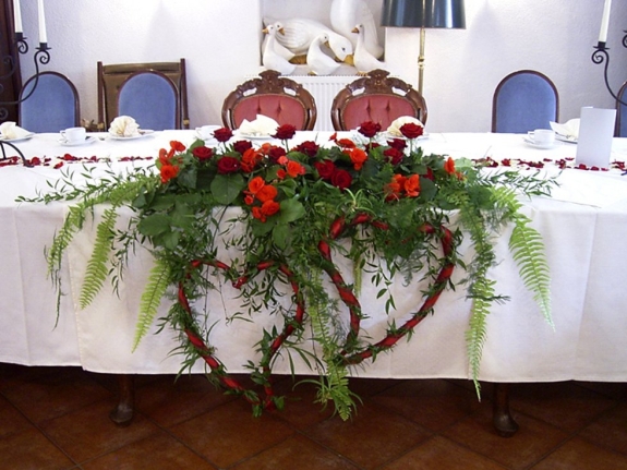 Brautpaartischgesteck mit roten Herzen